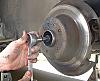 W123 A How to, replacing rear axles.-7-remove-wheel-hub-axle-bolt-hang-axle-caliper.jpg